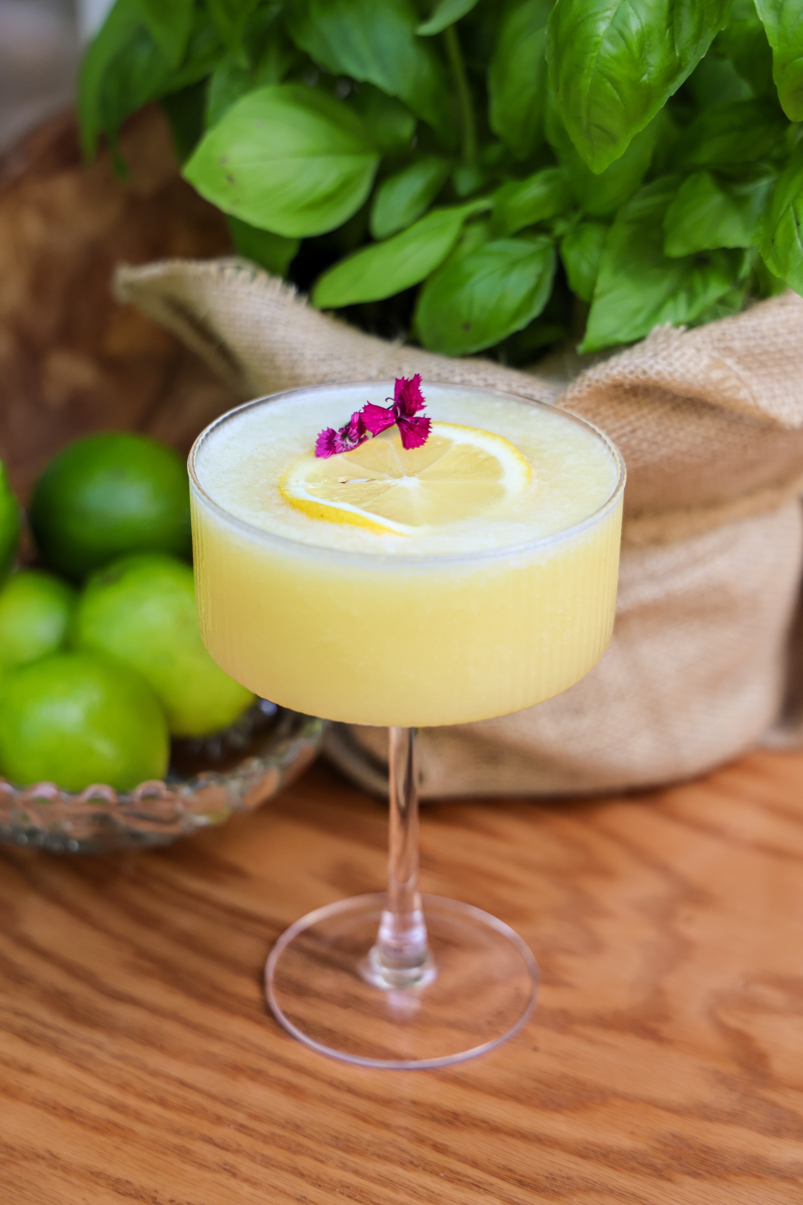 Lemon basil cocktail with flower garnish