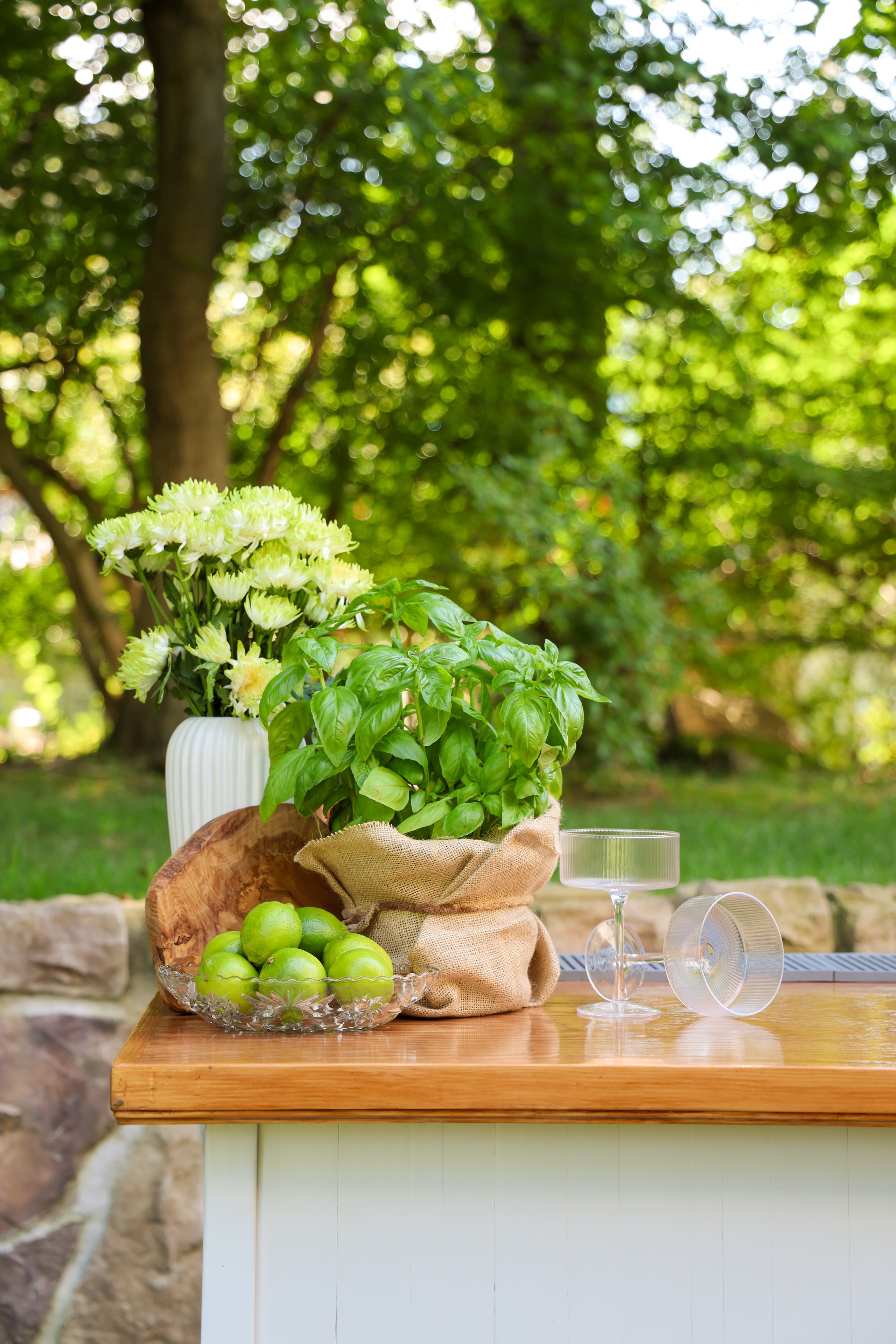 Garden table with flowers and fresh limes