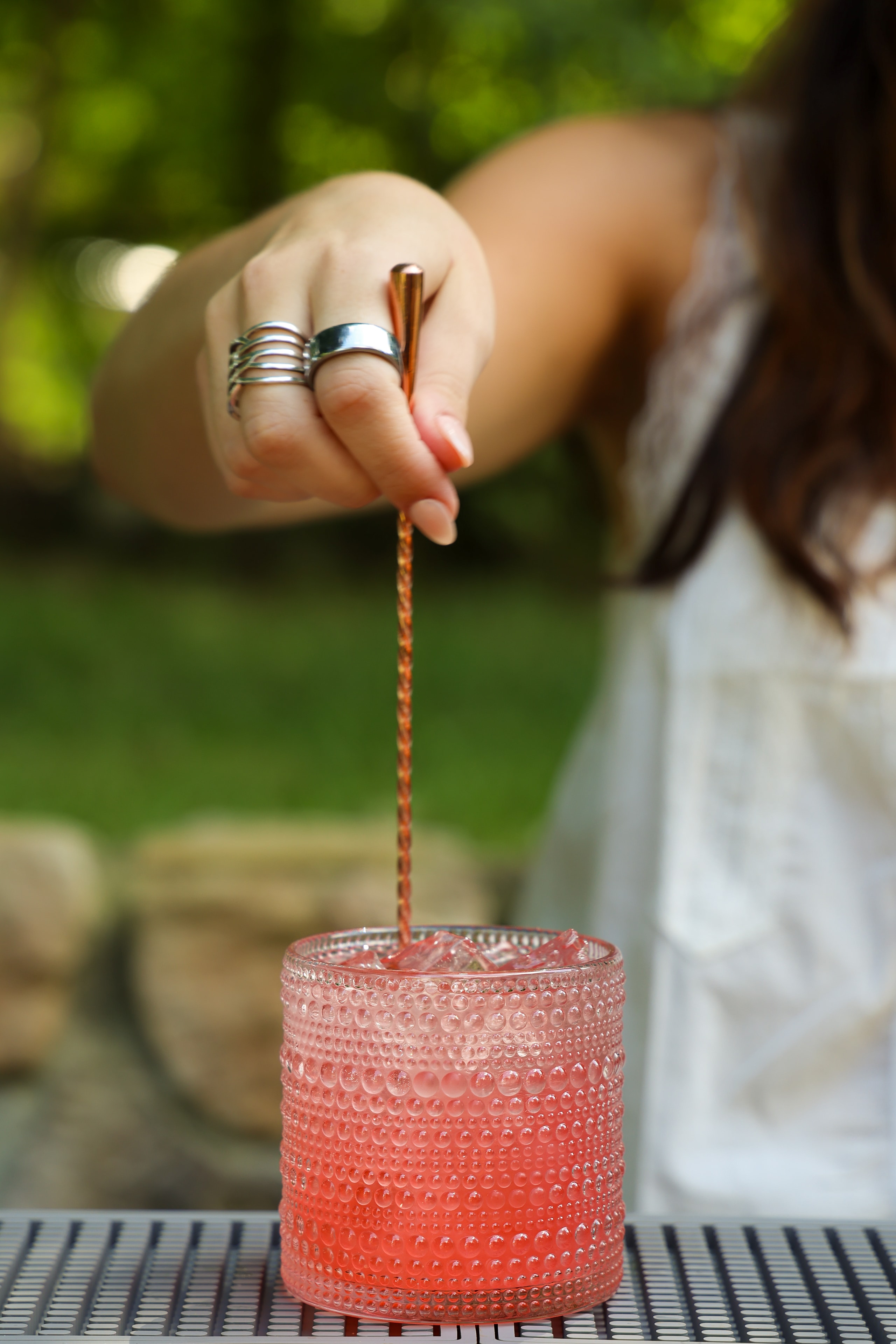 Blush Crafted cocktail being stirred outdoors